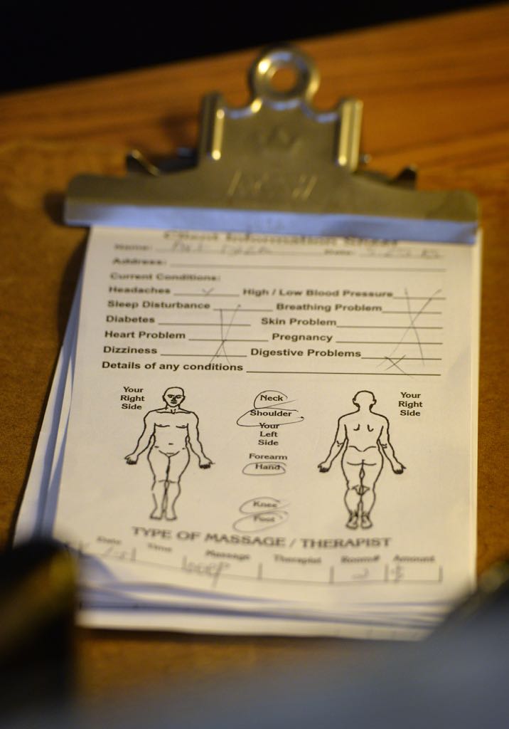 Customers can fill out a sheet telling their therapist where they'd like the massage to focus. Photo by Steven Georges/Behind the Badge OC