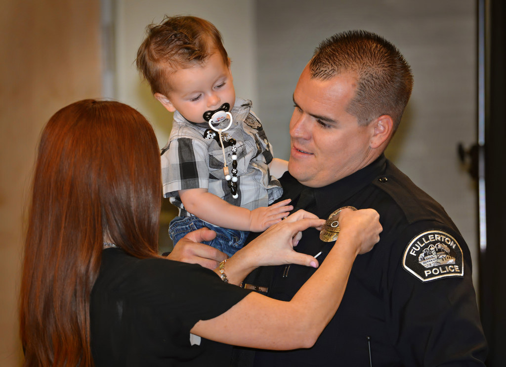 Jonathan Ferrell receives his police officer badge from his wife Katie, and son Jaxon, during Fullerton PD’s Promotions and Awards Ceremony. Ferrell comes from the Placentia Police Department. Photo by Steven Georges/Behind the Badge OC