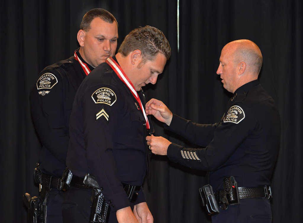 Corporal Jonathan Miller receives the Medal of Bravery from Chief Dan Hughes during Fullerton PD’s Promotions and Awards Ceremony. Photo by Steven Georges/Behind the Badge OC