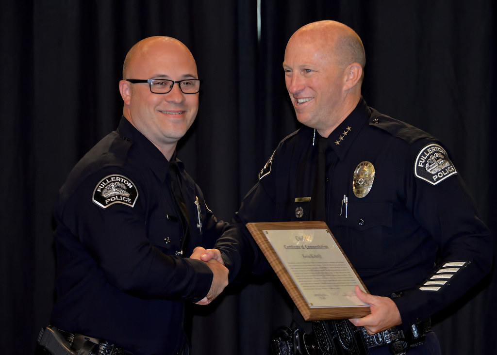 Officer Kevin Kirkreit receives the Chief’s Certificate of Commendation during Fullerton PD’s Promotions and Awards Ceremony, for an incident dealing with gang members under fire. Photo by Steven Georges/Behind the Badge OC