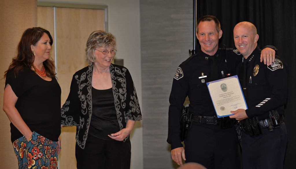 John Siko receives his promotion certificate and badge for the rank of Captain from Chief Dan Hughes with his wife Leslie and his Mother Charlene next to him during Fullerton PD’s Promotions and Awards Ceremony. Photo by Steven Georges/Behind the Badge OC