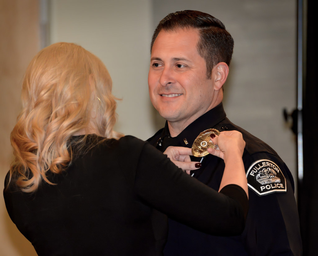 Thomas Oliveras has his new badge with the rank of Lieutenant pinned to him by his wife Jillian during Fullerton PD’s Promotions and Awards Ceremony. Photo by Steven Georges/Behind the Badge OC