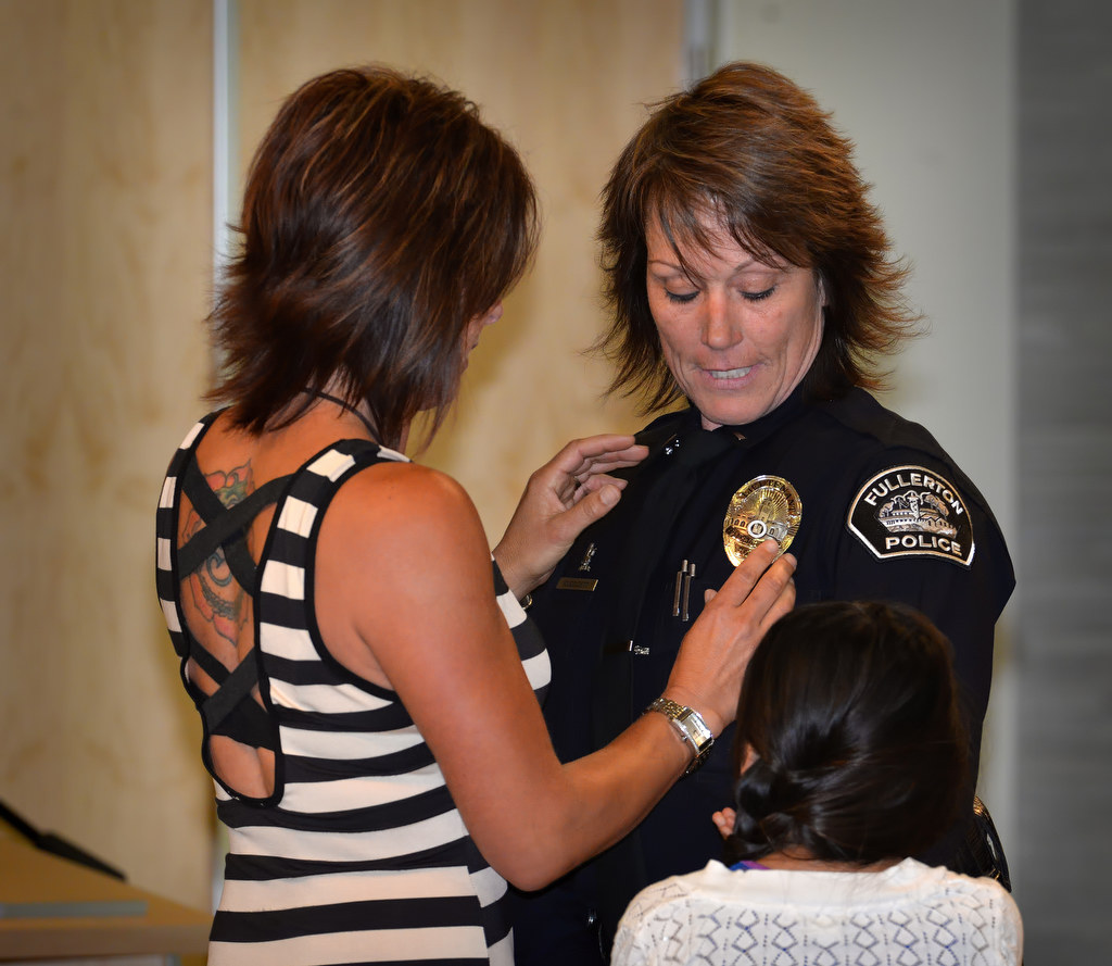 Rhonda Cleggett has her new badge with the rank of Lieutenant pinned to her by her partner, Danielle, and daughter Parker during Fullerton PD’s Promotions and Awards Ceremony. Photo by Steven Georges/Behind the Badge OC