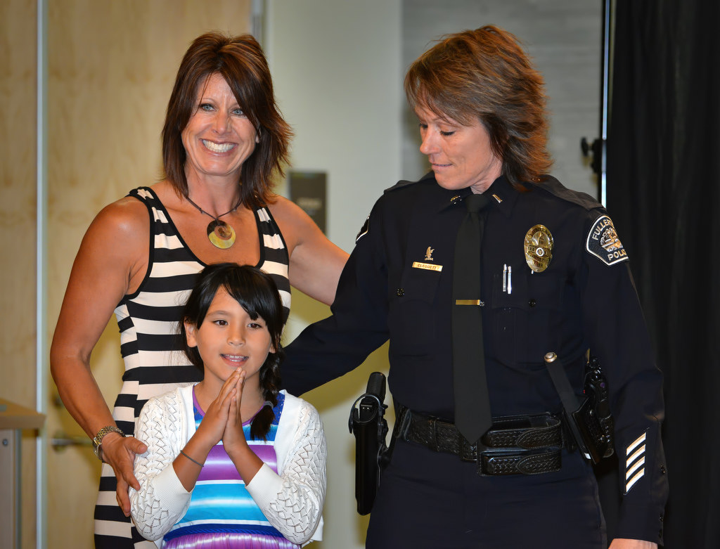 Rhonda Cleggett stands with her partner, Danielle, and daughter Parker after receiving her new badge with the rank of Lieutenant during Fullerton PD’s Promotions and Awards Ceremony. Photo by Steven Georges/Behind the Badge OC