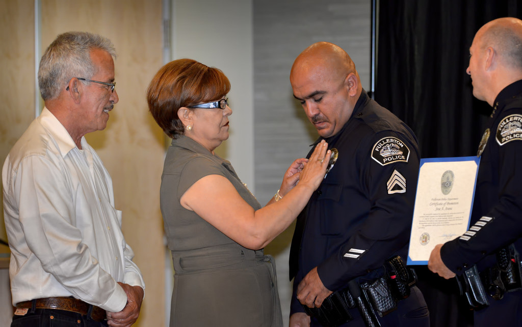 Jose Arana has his new badge with the rank of Sergeant pinned to him by His parents, Alberto and Martha during Fullerton PD’s Promotions and Awards Ceremony. Photo by Steven Georges/Behind the Badge OC