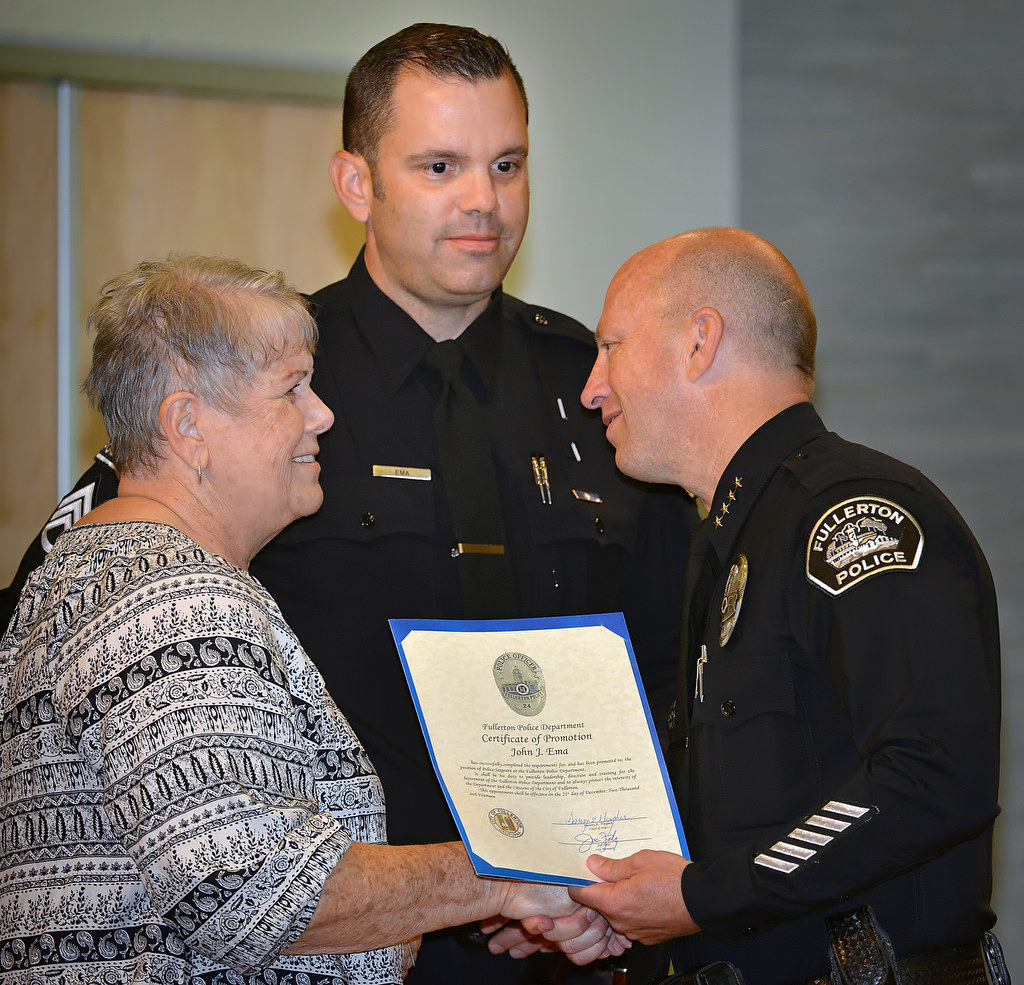 Chief Dan Hughes greets Pat as her son John Ema receives his new badge for the rank of Sergeant during Fullerton PD’s Promotions and Awards Ceremony. Photo by Steven Georges/Behind the Badge OC