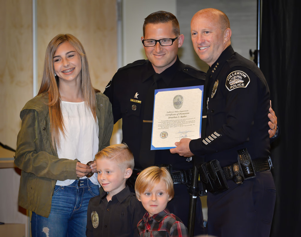 Jon Radus receives his promotion certificate and badge for the rank of Sergeant while with his daughter Payton and two sons Cade and Jax during Fullerton PD’s Promotions and Awards Ceremony. Photo by Steven Georges/Behind the Badge OC
