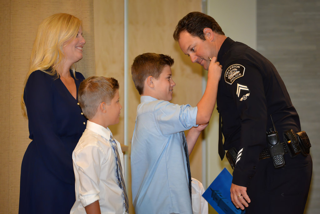 Stephen Bailor has his new Corporal badge pinned to him by his kids Cade, Cole, and Reed and his wife Summer during Fullerton PD’s Promotions and Awards Ceremony. Photo by Steven Georges/Behind the Badge OC