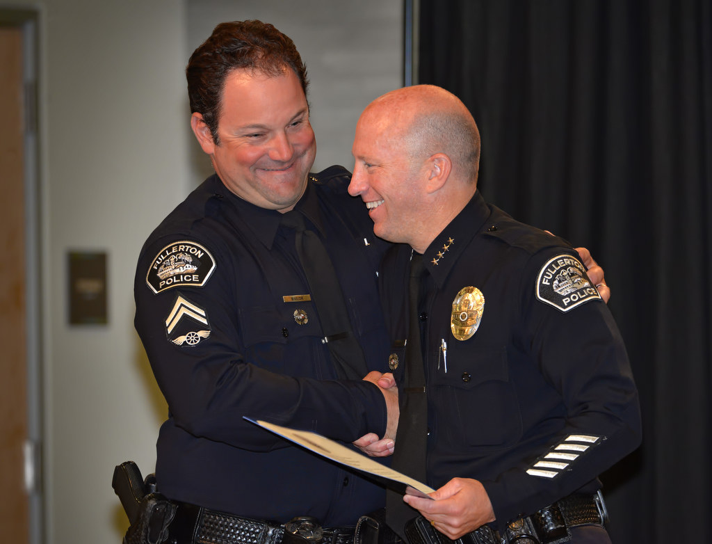 Stephen Bailor smiles as he receives his promotion certificate to the rank of Corporal from Chief Dan Hughes during Fullerton PD’s Promotions and Awards Ceremony. Photo by Steven Georges/Behind the Badge OC
