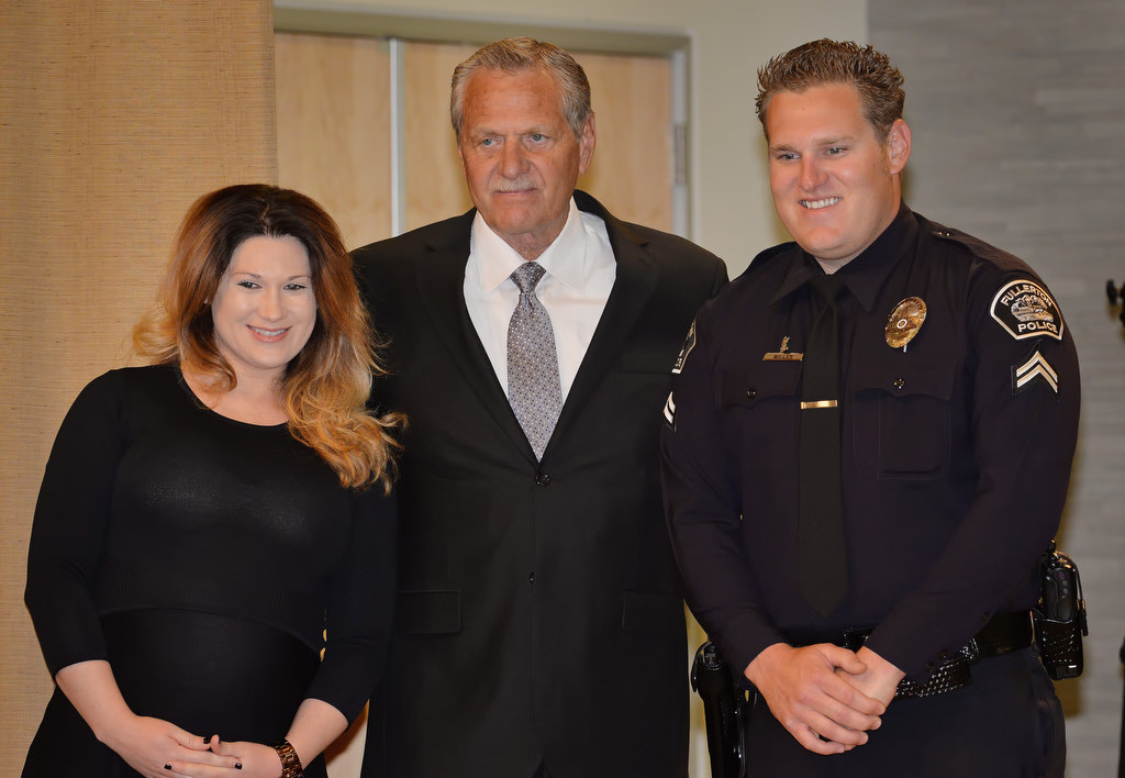 Jonathan Miller, right, stands with his wife, Melissa and Father, Bill, after receiving his new badge with the rank of Corporal during Fullerton PD’s Promotions and Awards Ceremony. Photo by Steven Georges/Behind the Badge OC