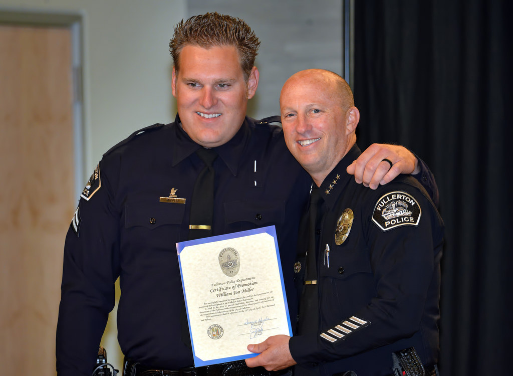 Jonathan Miller receives a promotion certificate to the rank of Corporal from Chief Dan Hughes during Fullerton PD’s Promotions and Awards Ceremony. Photo by Steven Georges/Behind the Badge OC