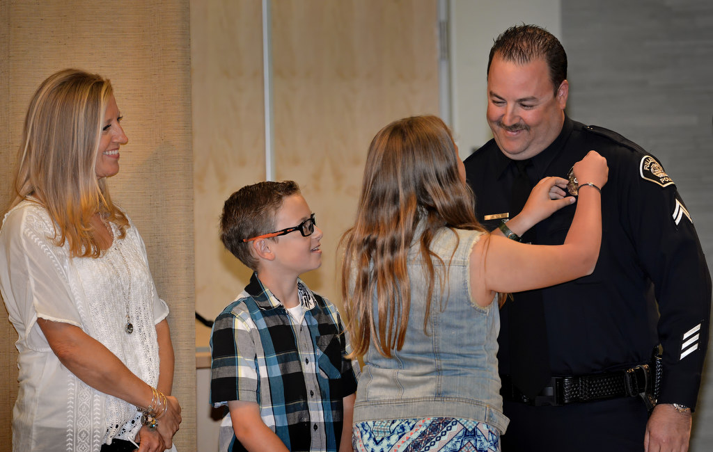 Gary Sirin has his new Corporal badge pinned on him by his kids Elisa and Kirk and wife Joele during Fullerton PD’s Promotions and Awards Ceremony. Photo by Steven Georges/Behind the Badge OC