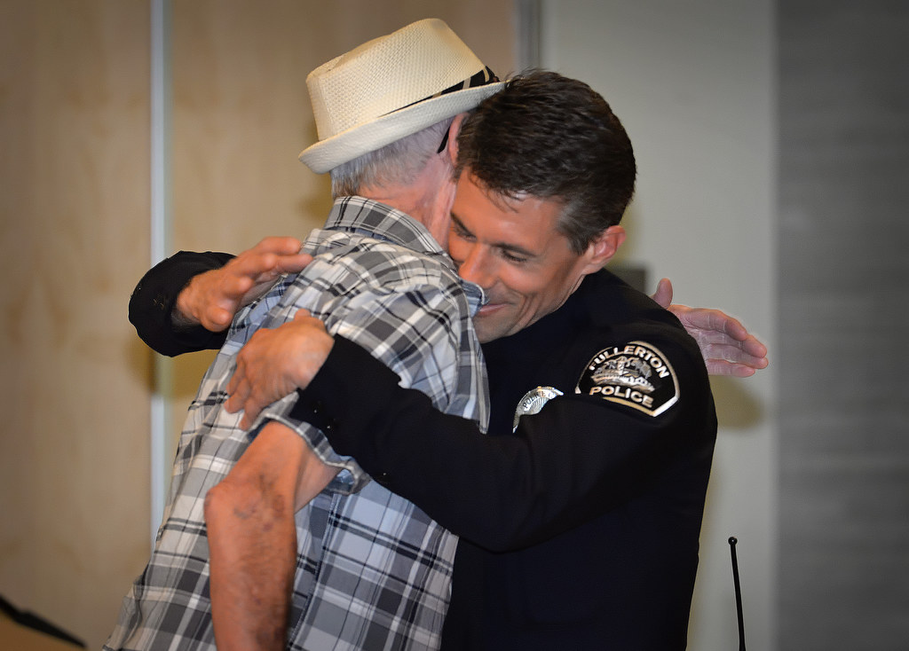 Chad Keen, who returns to the Fullerton PD from the State of Florida where he worked as a police officer and a deputy sheriff, gets a hug from his uncle Vernon after receiving his police officer badge during Fullerton PD’s Promotions and Awards Ceremony. Photo by Steven Georges/Behind the Badge OC