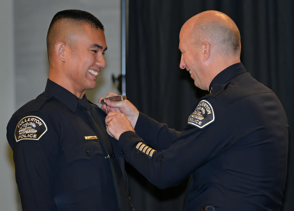 Long Phan, who served in Afghanistan with the U.S. Army, receives his police officer badge from Chief Dan Hughes during Fullerton PD’s Promotions and Awards Ceremony. Photo by Steven Georges/Behind the Badge OC