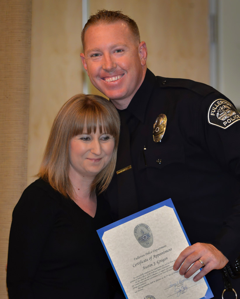 Austin Grogan, a retired Marine who was deployed in Iraq and who has a Bachelor’s degree from San Jose State University, stands with his wife Anne after receiving his police officer badge during Fullerton PD’s Promotions and Awards Ceremony. Photo by Steven Georges/Behind the Badge OC