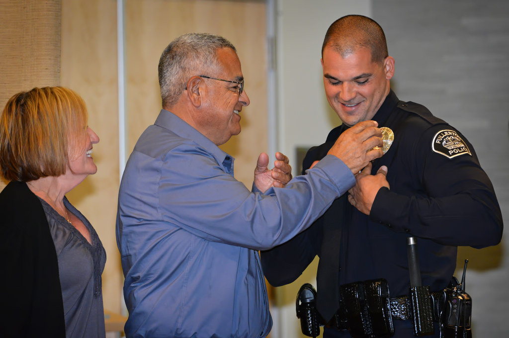 Justin Melendez receives his police officer badge from his parents, Gregory and Margaret, during Fullerton PD’s Promotions and Awards Ceremony. Photo by Steven Georges/Behind the Badge OC