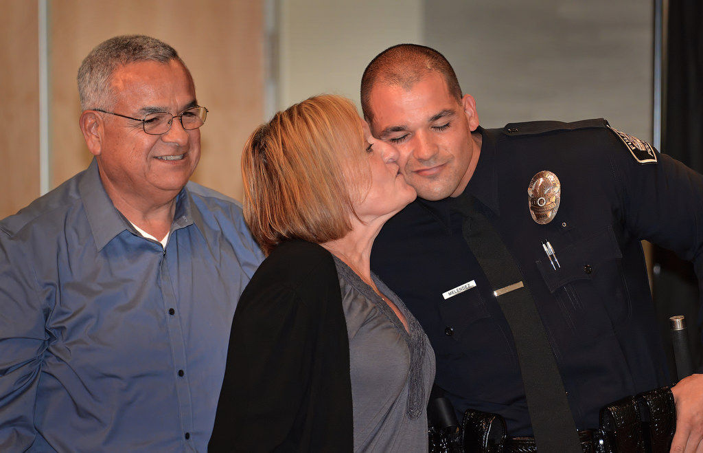 Justin Melendez gets a kiss from his mother Margaret after receiving his police officer badge from his mother and father, Gregory, during Fullerton PD’s Promotions and Awards Ceremony. Photo by Steven Georges/Behind the Badge OC
