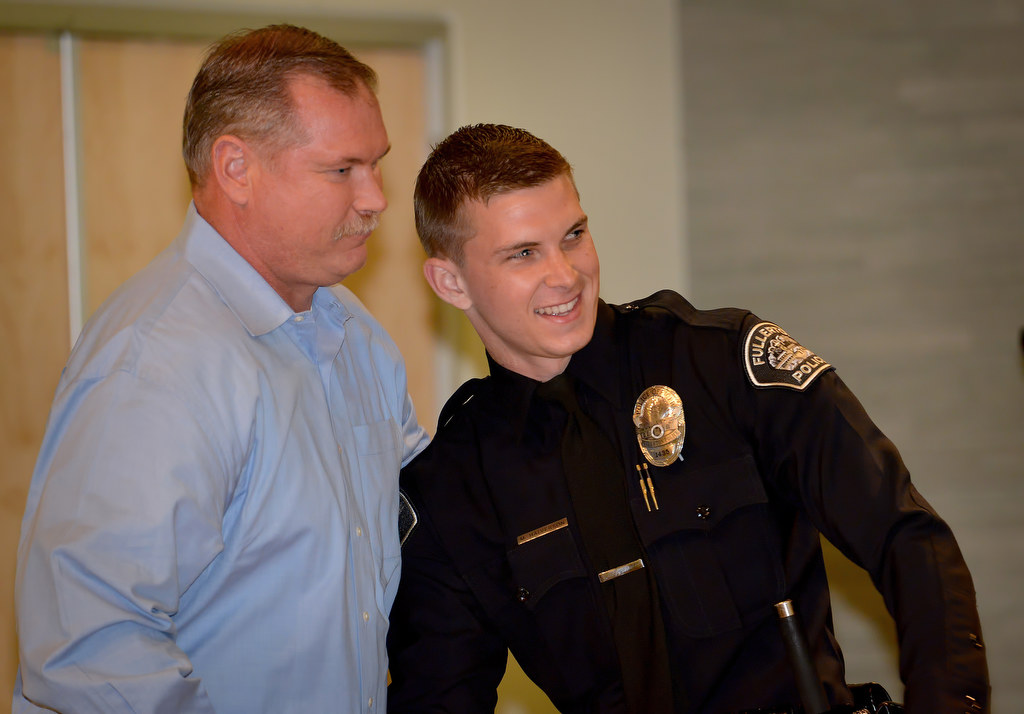 Michael Halverson, left, stands with his father, retired Fullerton PD Sergeant Eric Halverson, after receiving his police officer badge from his father during Fullerton PD’s Promotions and Awards Ceremony. Photo by Steven Georges/Behind the Badge OC