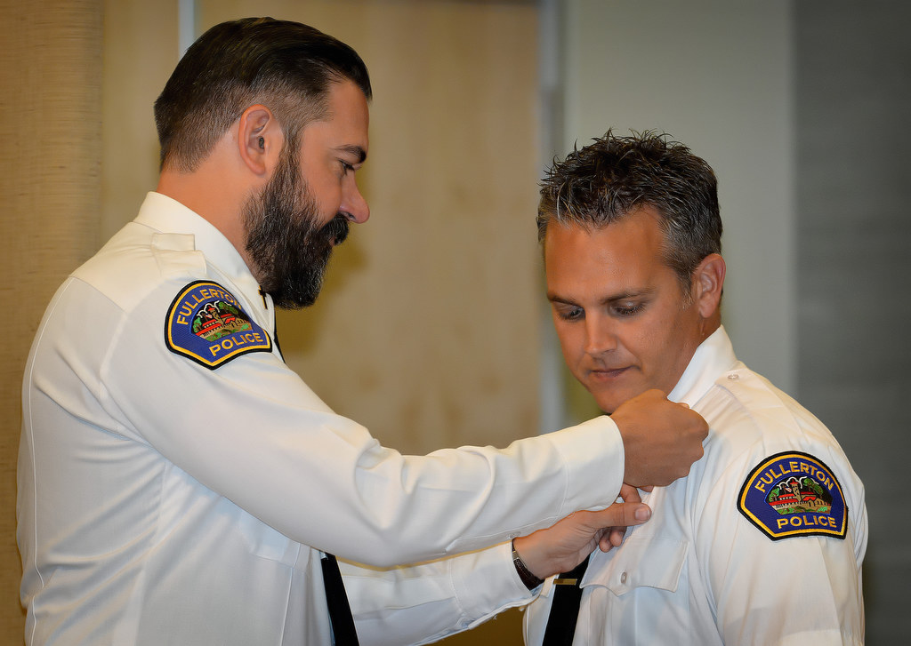 FPD Pastor Jason Phillips, left, pins Fullerton PD’s newest chaplain Richard Miller during Fullerton PD’s Promotions and Awards Ceremony. Photo by Steven Georges/Behind the Badge OC