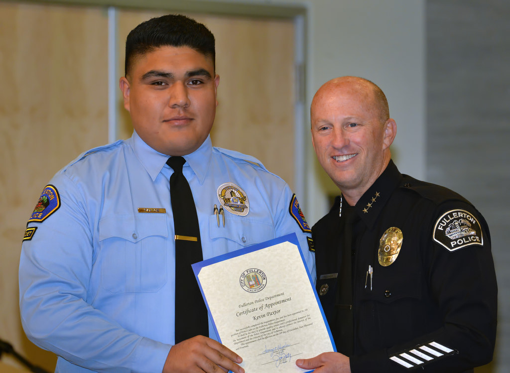 Kevin Paxtor, who is currently attending Fullerton College pursuing a major in Criminal Justice, receives his appointment certificate for the position of Fullerton Police Cadet from Chief Dan Hughes during Fullerton PD’s Promotions and Awards Ceremony. Photo by Steven Georges/Behind the Badge OC