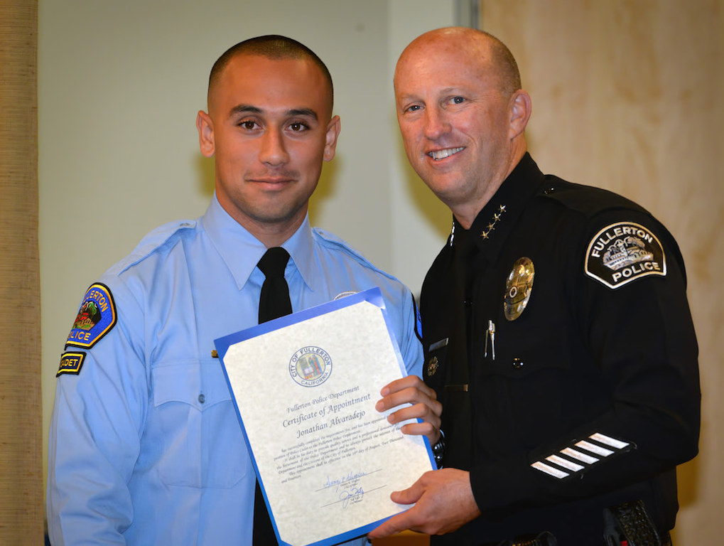 Jonathan Alvaradejo, who currently has an Associates Degree from Santa Ana College and is working towards a Bachelor’s Degree in Public Administration, receives his appointment certificate for the position of Fullerton Police Cadet from Chief Dan Hughes during Fullerton PD’s Promotions and Awards Ceremony. Photo by Steven Georges/Behind the Badge OC