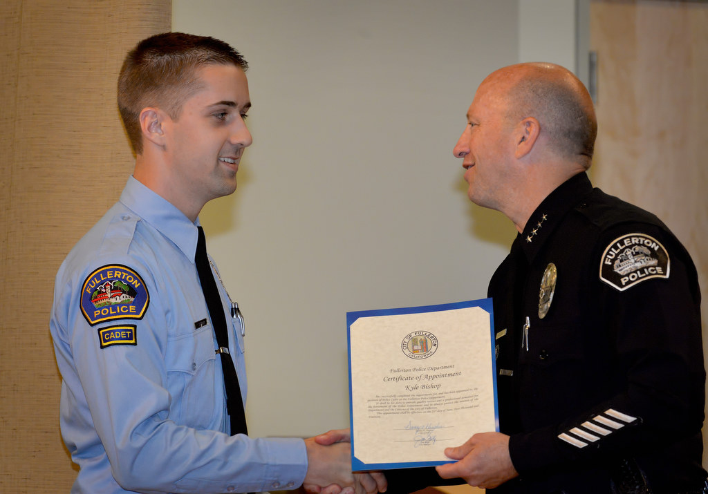 Kyle Bishop, who was born and raised in Fullerton, receives his appointment certificate for the position of Fullerton Police Cadet from Chief Dan Hughes during Fullerton PD’s Promotions and Awards Ceremony. Photo by Steven Georges/Behind the Badge OC