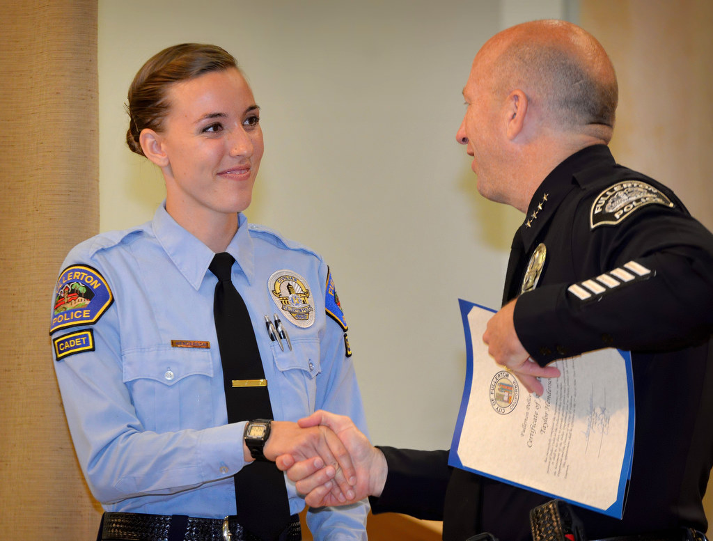 Taylor Henderson, who has a Political Science degree from Hope University, receives her appointment certificate for the position of Fullerton Police Cadet from Chief Dan Hughes during Fullerton PD’s Promotions and Awards Ceremony. Photo by Steven Georges/Behind the Badge OC