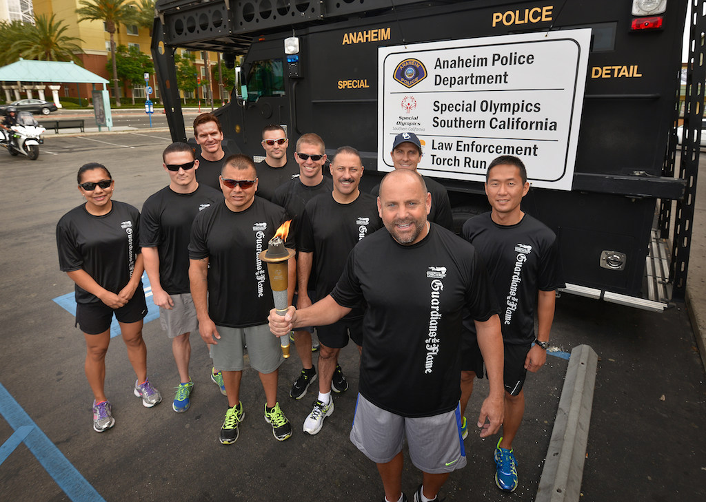 The Anaheim team receive the torch during the Law Enforcement Torch Run for Special Olympics. Photo by Steven Georges/Behind the Badge OC
