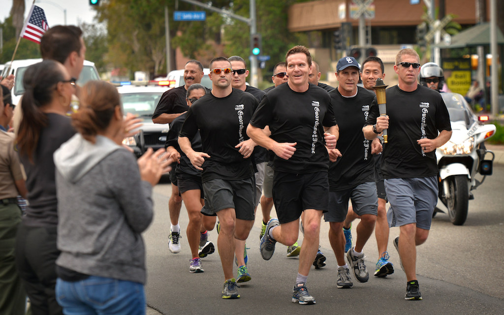 Anaheim PD officers take the Special Olympic torch up Harbor Blvd. past Anaheim Police Headquarters Friday morning. Photo by Steven Georges/Behind the Badge OC
