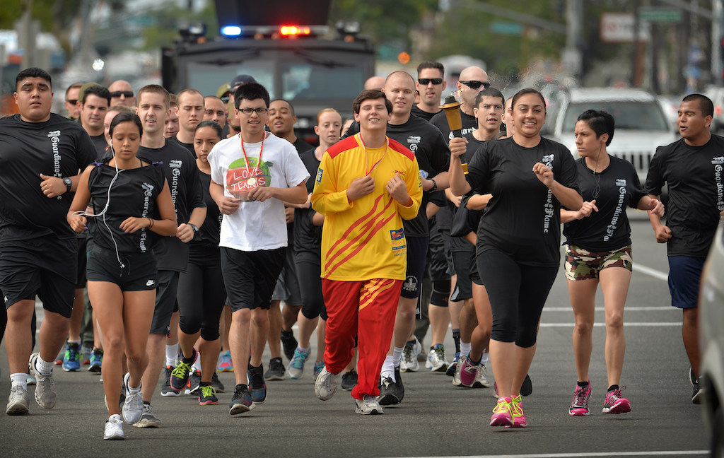 The Fullerton PD team runs with the torch up Harbor Blvd. during the Law Enforcement Torch Run for Special Olympics. Photo by Steven Georges/Behind the Badge OC