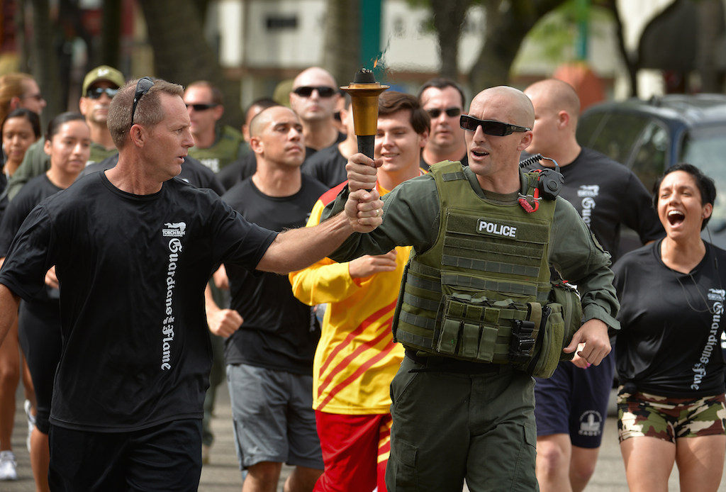 The Fullerton PD team runs with the torch up Harbor Blvd. during the Law Enforcement Torch Run for Special Olympics. Photo by Steven Georges/Behind the Badge OC