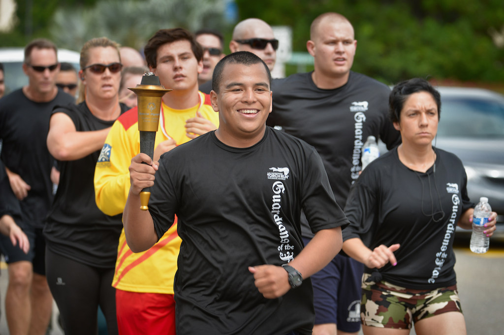 The Fullerton PD team runs with the torch down Chapman Ave. during the Law Enforcement Torch Run for Special Olympics. Photo by Steven Georges/Behind the Badge OC