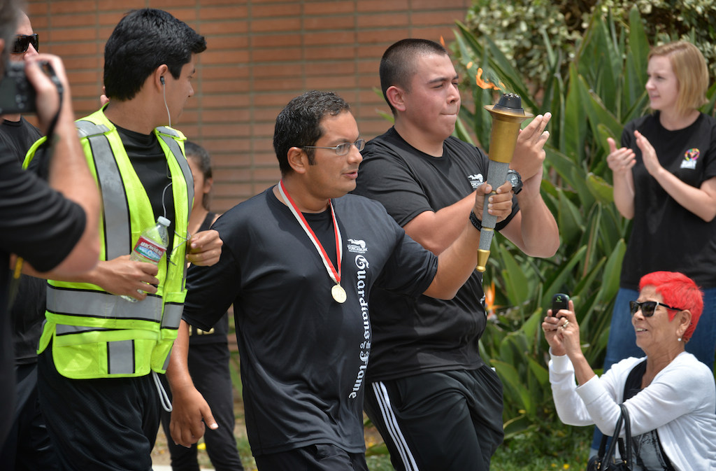 The La Habra PD team runs with the torch up Euclid St. to the La Habra Police Department to conclude Saturdays Law Enforcement Torch Run for Special Olympics. Photo by Steven Georges/Behind the Badge OC