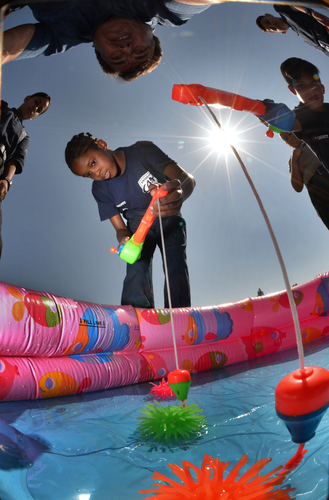 Junior cadet Antonia Gathecha uses her motor skills to pickup an object at the end of a tiring obstacle course during Anaheim PDÕs Cops 4 Kids Jr. Cadet Academy at Betsy Ross Elementary. Photo by Steven Georges/Behind the Badge OC