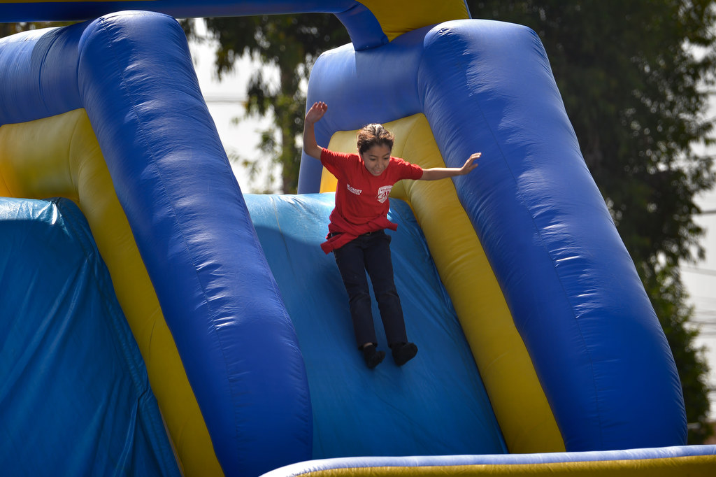 Junior cadet Valeris Herrera flies down a giant slide on the final day of Anaheim PDÕs Cops 4 Kids Jr. Cadet Academy at Betsy Ross Elementary. Photo by Steven Georges/Behind the Badge OC