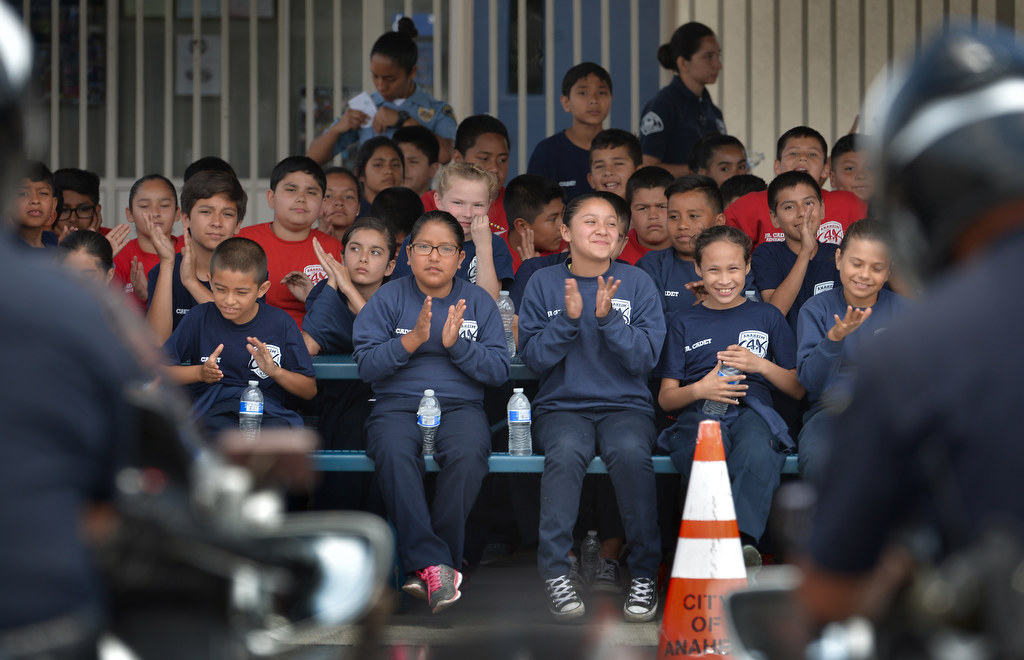 Junior cadets applaud Anaheim motorcycle officers at the conclusion of their demonstration during Anaheim PD Cops 4 Kids Jr. Cadet Academy at Betsy Ross Elementary. Photo by Steven Georges/Behind the Badge OC