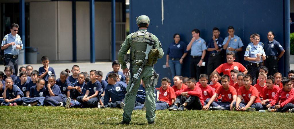 Anaheim SWAT Officer Kevin Voorhis talks to junior cadets during a SWAT demonstration for Anaheim PD Cops 4 Kids Jr. Cadet Academy at Betsy Ross Elementary. Photo by Steven Georges/Behind the Badge OC