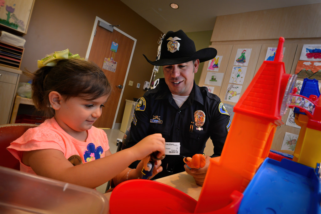 Amelia Smith, 6, of Arizona, plays pirate princes with Anaheim Police Officer Eric Anderson during a visit to CHOC (Children's Hospital of Orange County). Photo by Steven Georges/Behind the Badge OC