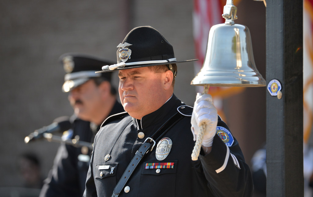 Officer Charles Danieley rings the bell for each Garden Grove fallen officer as Capt. Ben Stauffer, left, reads their names during the Tolling of the Memorial Bell for the Fallen Officers Honor Guard Presentation, part of the Garden Grove PD's 28th Annual "Call to Duty" Memorial Service on June 11. Photo by Steven Georges/Behind the Badge OC