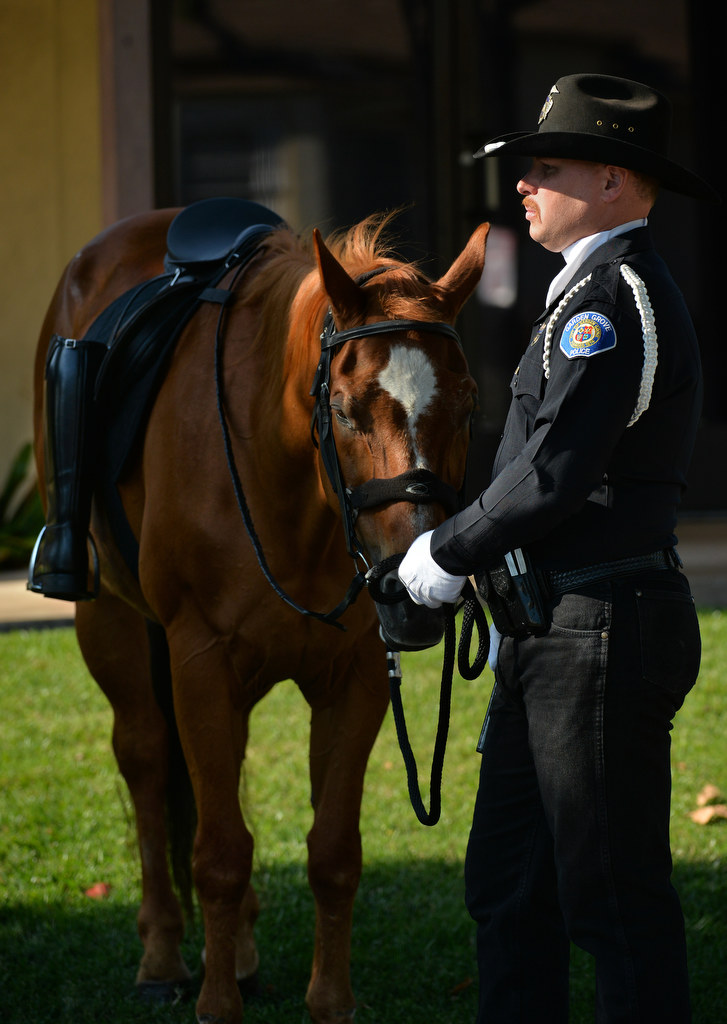 Garden Grove Police Officer Taylor Macy leads “Cadillac” as part of the Riderless Horse tradition during Garden Grove PD’s 28th Annual “Call to Duty” Memorial Service. The empty boots facing backwards is a tradition signifying “a soldier’s march had ended and that he was able to look back on his troops.” Photo by Steven Georges/Behind the Badge OC