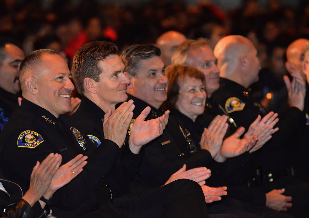 Anaheim Police Chief Raul Quezada, left, and Deputy Chief Julian Harvey join the rest of Anaheim PD’s command staff in applauding the speeches given by some of the junior cadets during Anaheim PD’s Jr. Cadet Graduation Ceremony at the Anaheim Convention Center. Photo by Steven Georges/Behind the Badge OC