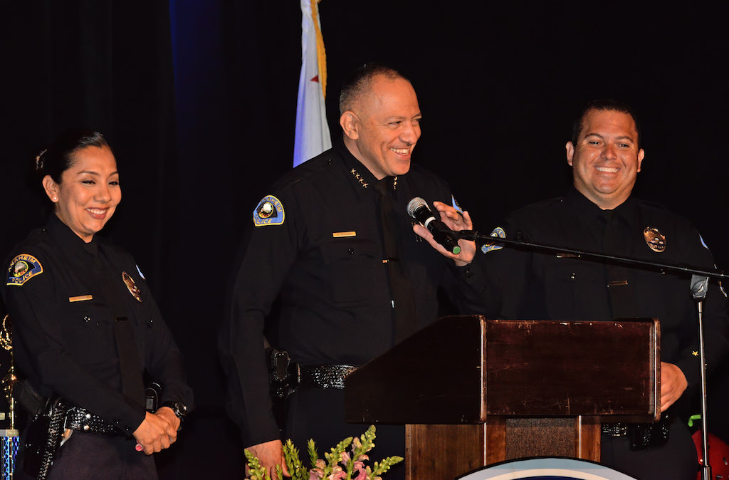 Anaheim Police Chief Raul Quezada takes the stage to thank Officer Leslie Vargas, left, and Sgt. Jake Gallacher, right, for all their work with the junior cadets during Anaheim PD’s Jr. Cadet Graduation Ceremony at the Anaheim Convention Center. Photo by Steven Georges/Behind the Badge OC