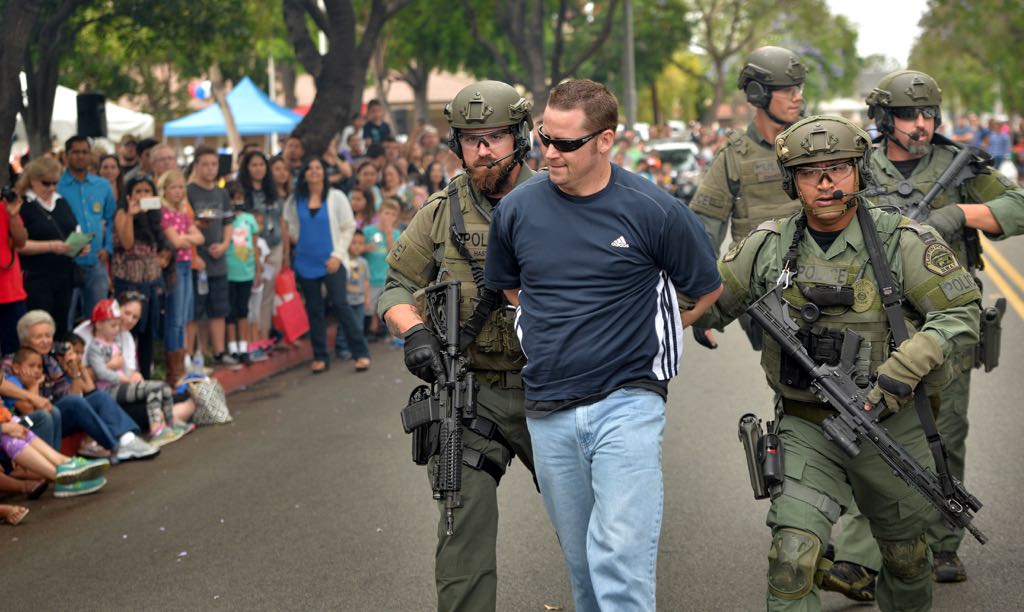 Tustin Police Officer Chuck Mitchell plays a suspect in a  SWAT demonstration at Tustin PD's 19th Annual Open House. Photo by Steven Georges/Behind the Badge OC