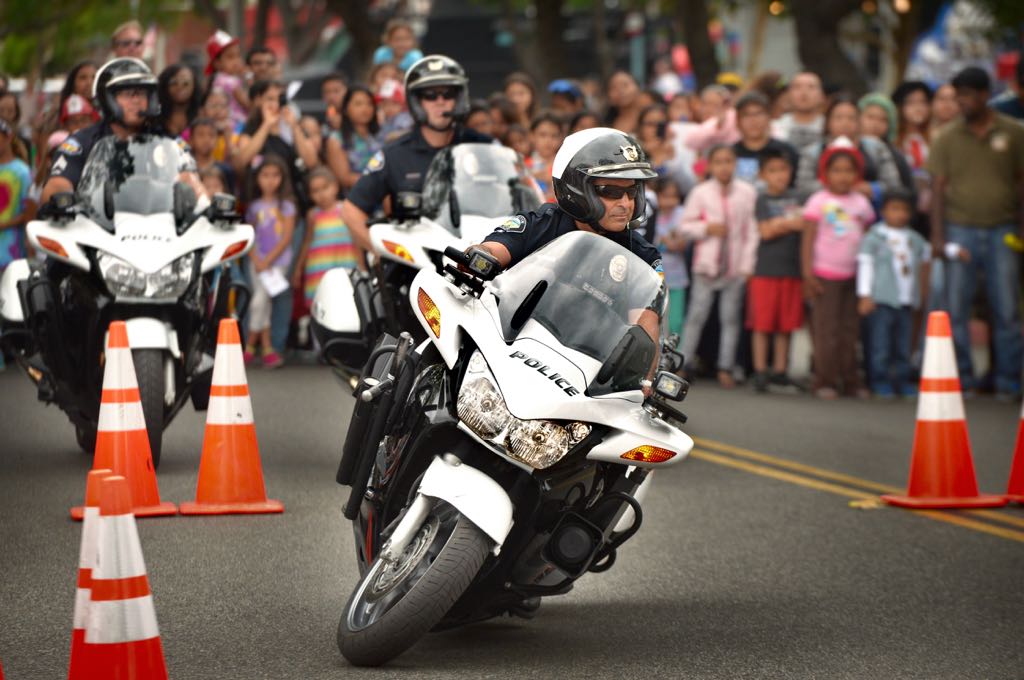 Tustin Police Motorcycle Officer Ralph Casiello, front, helps put on a police motorcycle demonstration for the crowd gathered during Tustin PD’s 19th Annual Open House. Photo by Steven Georges/Behind the Badge OC