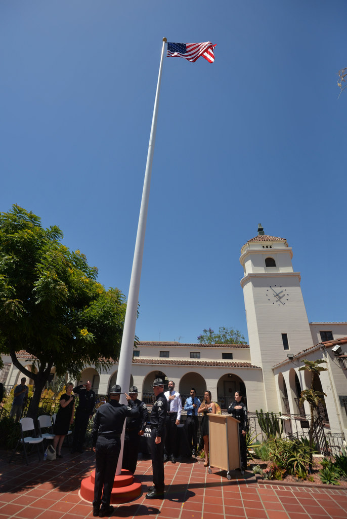 The Fullerton Police Department raise an American flag during a memorial in front of police headquarters honoring Fullerton Police Officer Tommy De La Rosa who was killed in the line of duty on June 21, 1990. Photo by Steven Georges/Behind the Badge OC