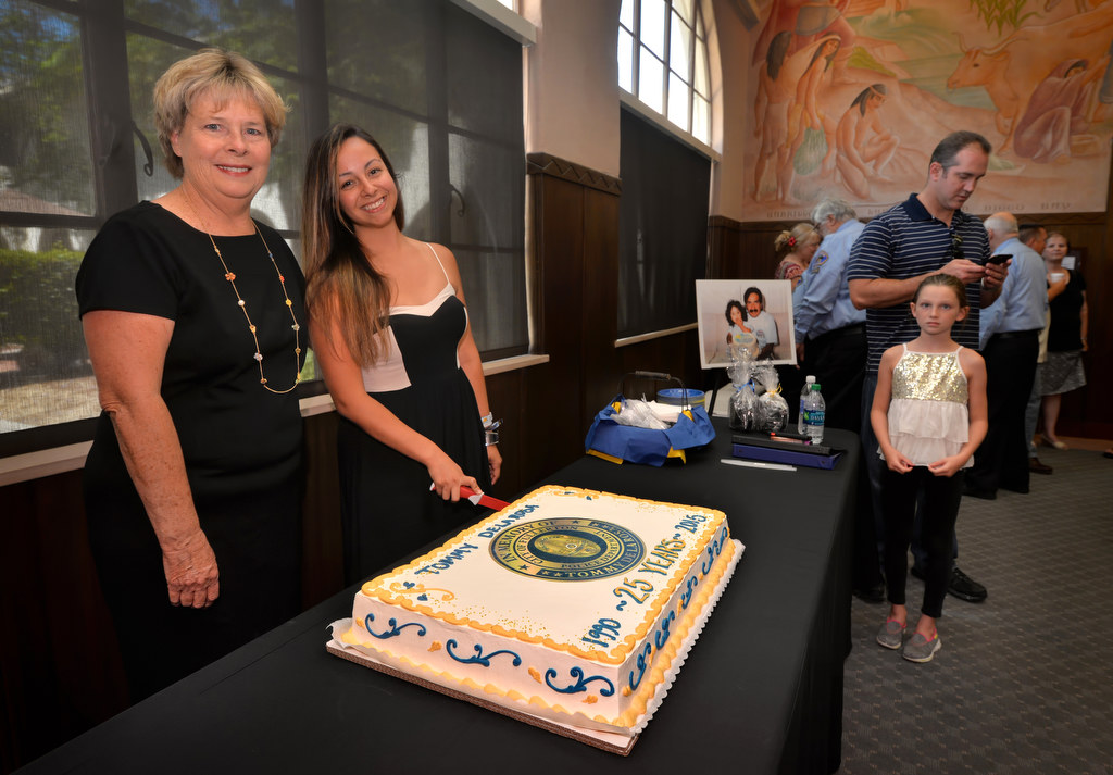Leslie De La Rosa, Tommy De La RosaÕs wife, left, and his daughter Ashley stand next to a cake during a memorial gathering for fallen Officer Tommy De La Rosa 25 years after he was killed in the line of duty. Photo by Steven Georges/Behind the Badge OC