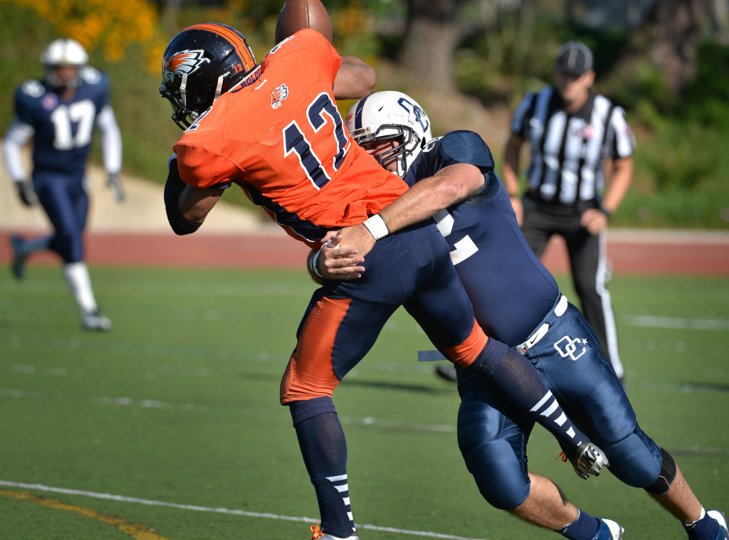 Orange County Lawmen Tommy Mellana (42) (Cypress PD) takes down New York Boldest’s quarterback Jamaine Powell (12) during their national championship game at Irvine High. Photo by Steven Georges/Behind the Badge OC