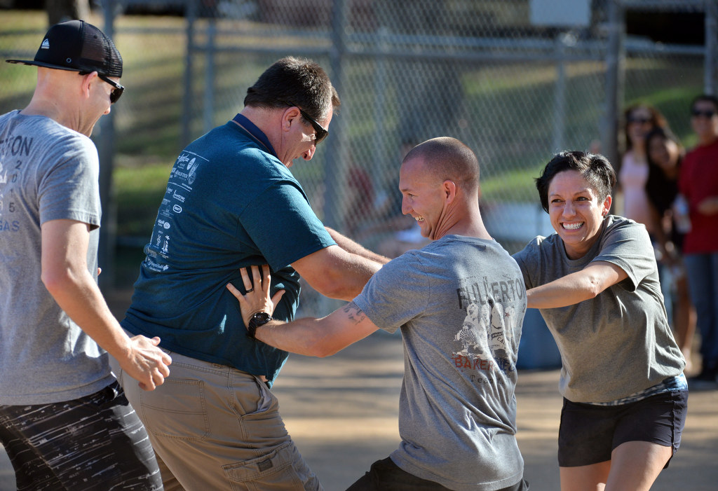 Fullerton Police Cpl. Ryan OÕNeil, left, Lt. Mike Chlebowski, Officer Tim Gibert and Officer Hazel Rios have a little fun during the P2: Picnic with the Police kickball game at Ted Craig Regional Park in Fullerton. Photo by Steven Georges/Behind the Badge OC