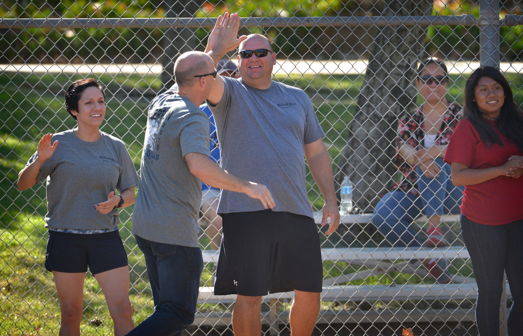 Fullerton Police Chief Dan Hughes gives high-fives to members of his team, made up of both FPD and Benizi Youth Leadership Team members, during a P2: Picnic with the Police kickball game. Photo by Steven Georges/Behind the Badge OC