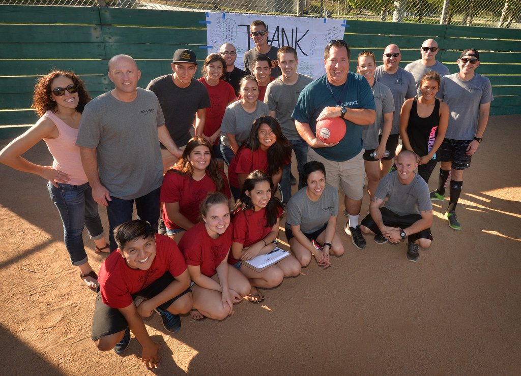 Fullerton police officers, Fullerton’s St. Philip Benizi Catholic Church’s Benizi Youth Leadership Team (BYLT), and Nonprofit Community Service Programs’ (CSP) Project PATH (Positive Action Toward Health) gather at the end of their P2: Picnic with the Police kickball game at Ted Craig Regional Park in Fullerton. Photo by Steven Georges/Behind the Badge OC